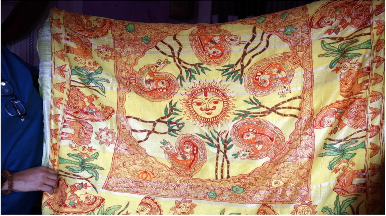 A cotton saree hand-painted with Chhath Puja motifs with Lord Surya painted at the center and the Parvaitins or devotees on the borders 