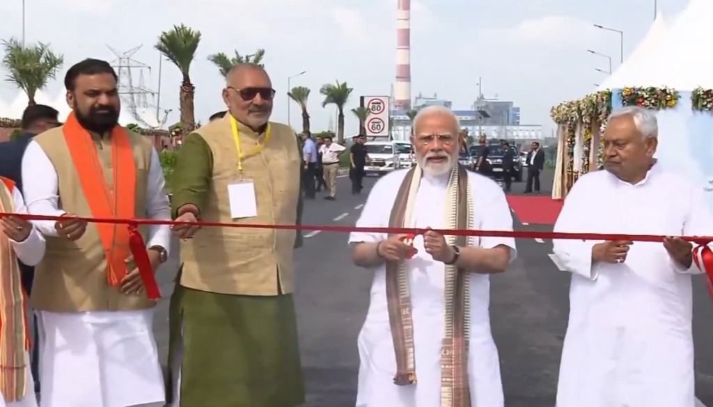 Prime Minister Narendra Modi cutting the ribbon to inaugurate Bihar’s Aunta–Simaria six-lane bridge over the Ganga, with a crowd gathered in the rain.