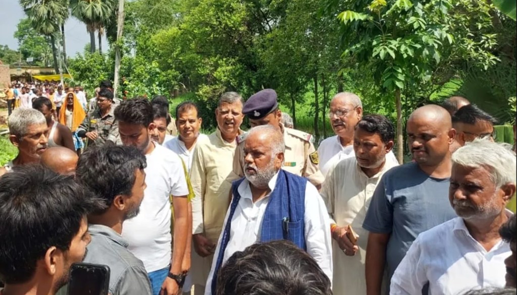 Rural Development Minister Shravan Kumar and Hilsa MLA Krishna Murari surrounded by villagers during a protest in Malama village, Nalanda district, Bihar.