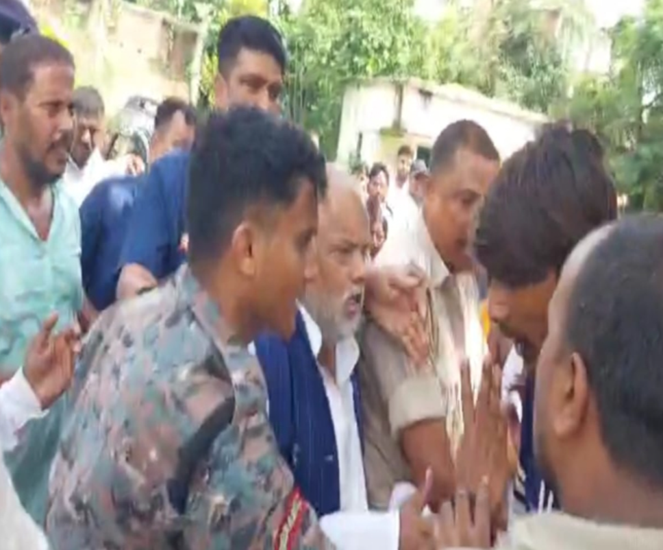 Rural Development Minister Shravan Kumar and Hilsa MLA Krishna Murari surrounded by villagers during a protest in Malama village, Nalanda district, Bihar.