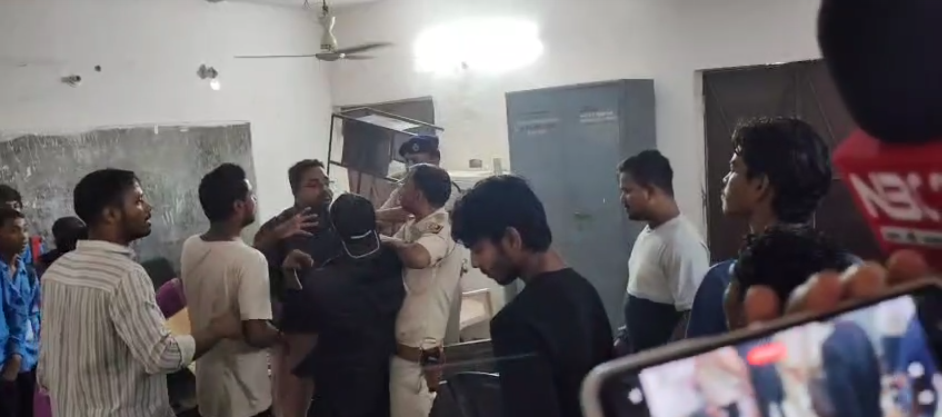 Crowds gather outside Amla Tola Kanya Vidyalaya in Patna after a 10-year-old schoolgirl set herself on fire, with heavy police deployment at the scene.