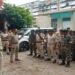 BSAP personnel armed with batons standing at a busy Patna intersection to manage protests and maintain law and order.