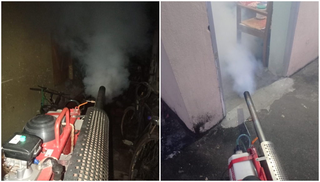 Workers from Patna Municipal Corporation conducting fogging and anti-larva spraying in a residential area to prevent dengue and mosquito-borne diseases.