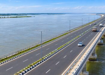 Representative AI image of a four-lane road running over the Kosi River on a raised bridge
