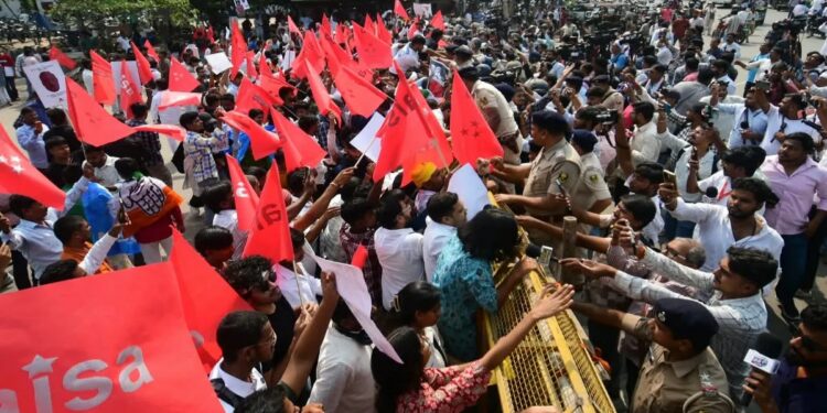 AISA protesters breach police barricades near Gandhi Maidan during a march towards Lok Bhavan in Patna against the Special Intensive Revision of electoral rolls.
