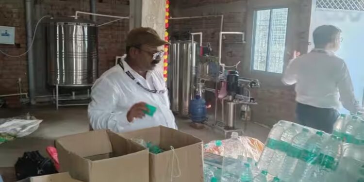 Food safety officials inspect packaged drinking water bottles with suspected fake branding in Patna.